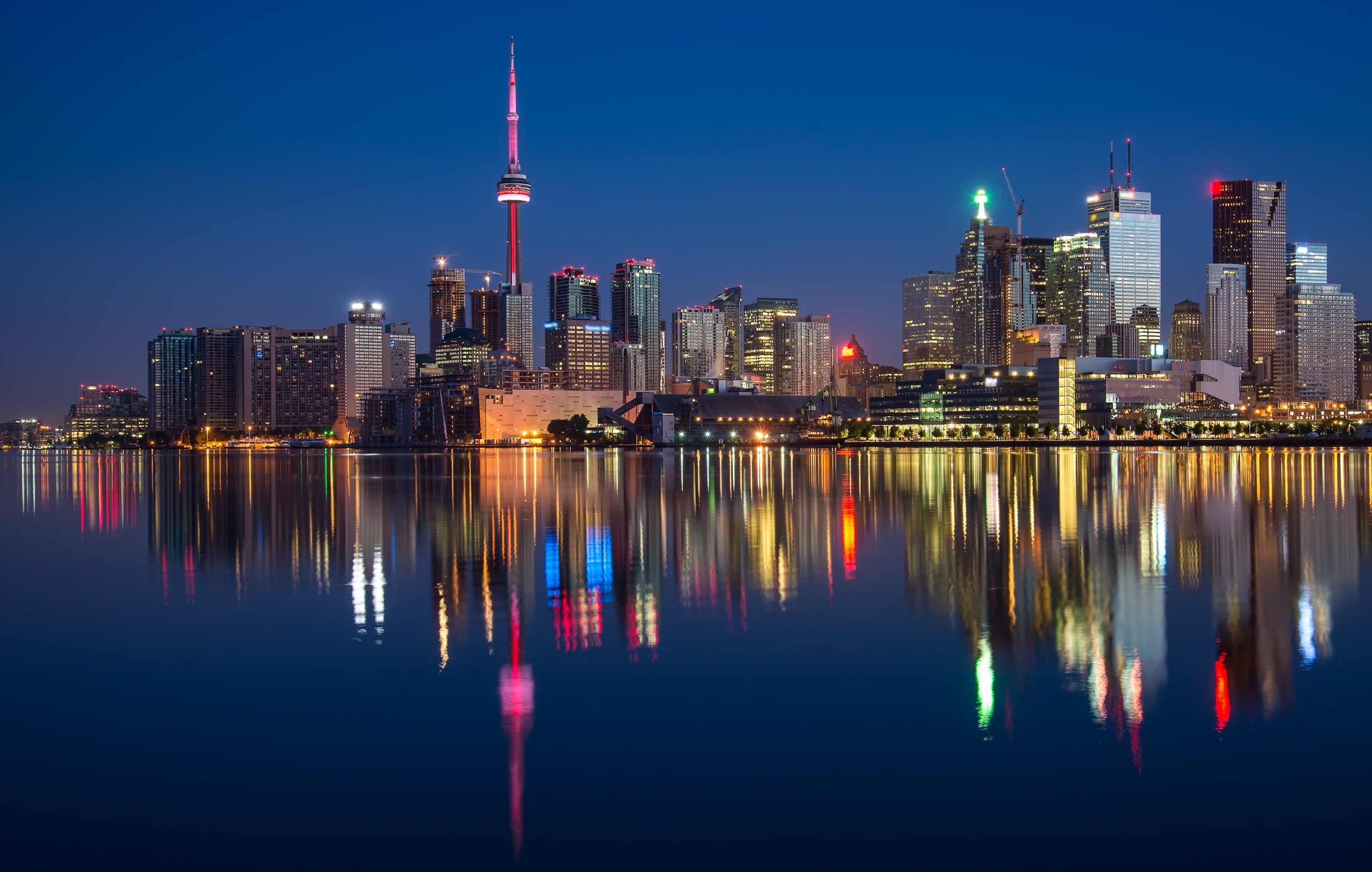 Free Buildings Near Body Of Water At Night  Stock Photo
